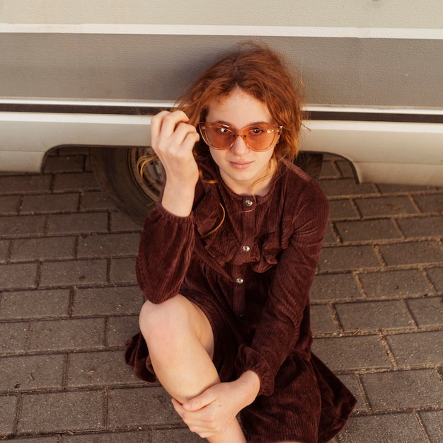 High angle girl posing with sunglasses