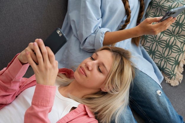 High angle girls holding smartphones