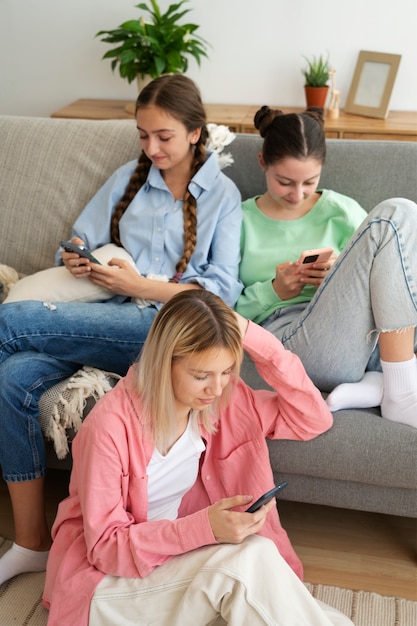 High angle girls holding smartphones