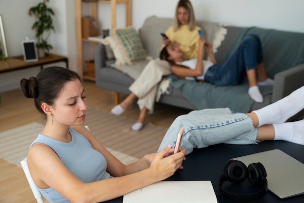 Free photo high angle girls with smartphone addiction