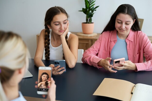 High angle girls with smartphones