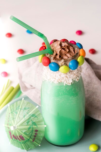 High angle of glass of dessert with colorful candy topping