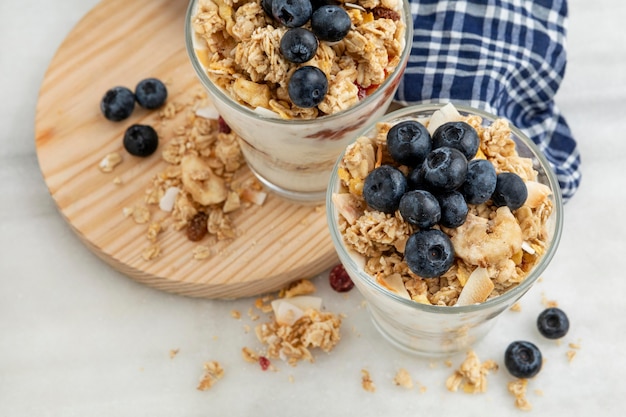 High angle of glasses with breakfast cereals and yogurt