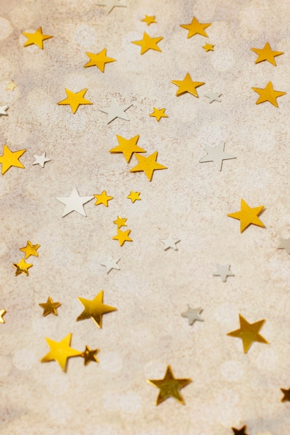 High angle golden stars ornaments on table