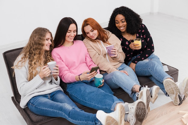 Free photo high angle group of women holding cups