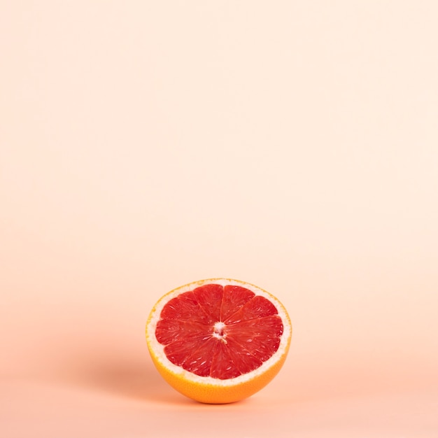 Free photo high angle half red orange with copy-space