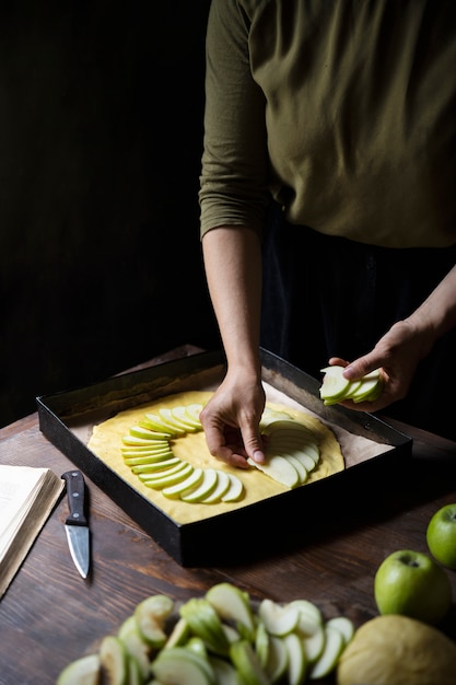 Free photo high angle hand arranging apple slices