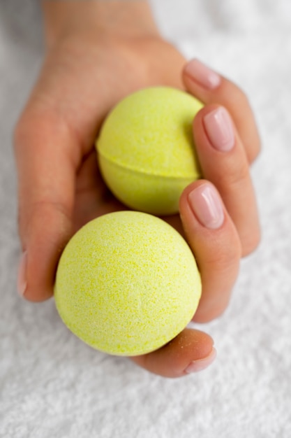 Free photo high angle hand holding bath bombs