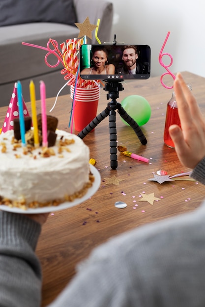 High angle hand holding birthday cake