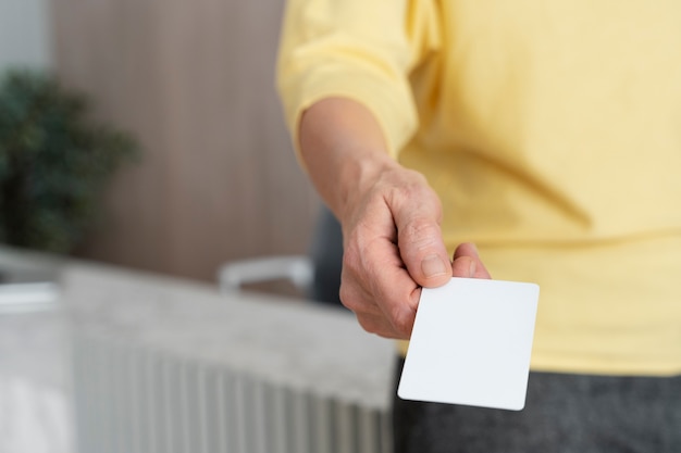 High angle hand holding blank business card