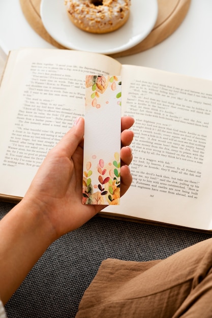 Free photo high angle hand holding bookmark