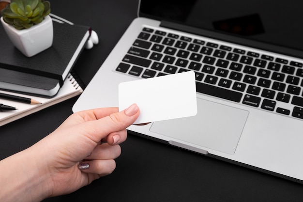 Free photo high angle of hand holding business card