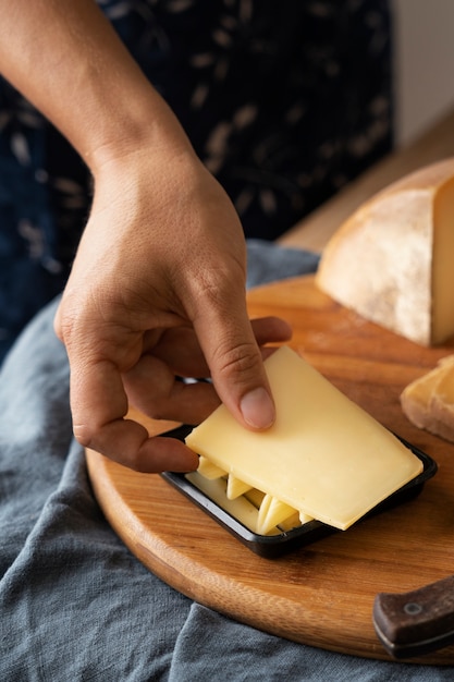 Free Photo high angle hand holding cheese slice