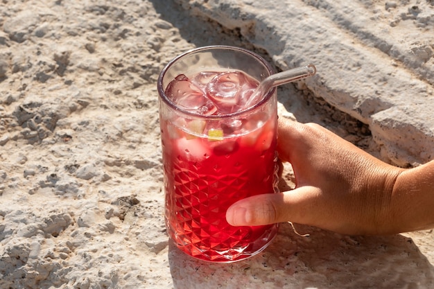 Free photo high angle hand holding sangria glass