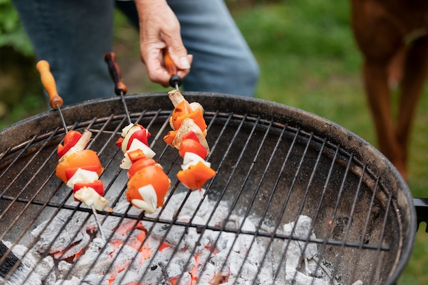 Free photo high angle hand holding skewers