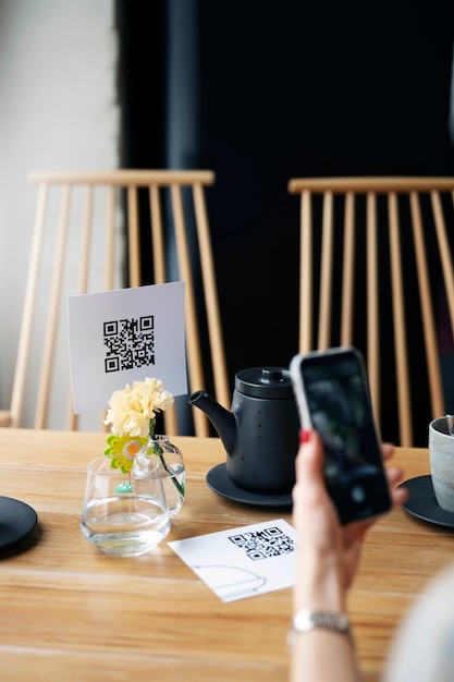 Free Photo high angle hand scanning qr code with phone