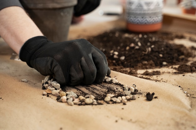 Free photo high angle hand with glove holding pebbles