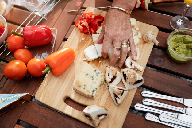 High angle hands cutting cheese