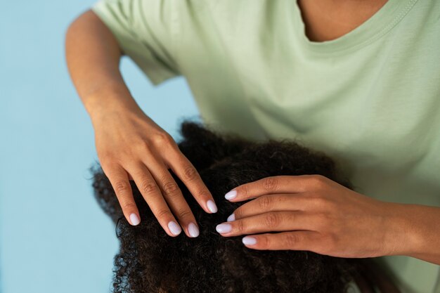 High angle hands helping kid with lice