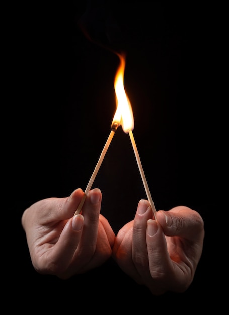 Free Photo high angle hands holding lit matches