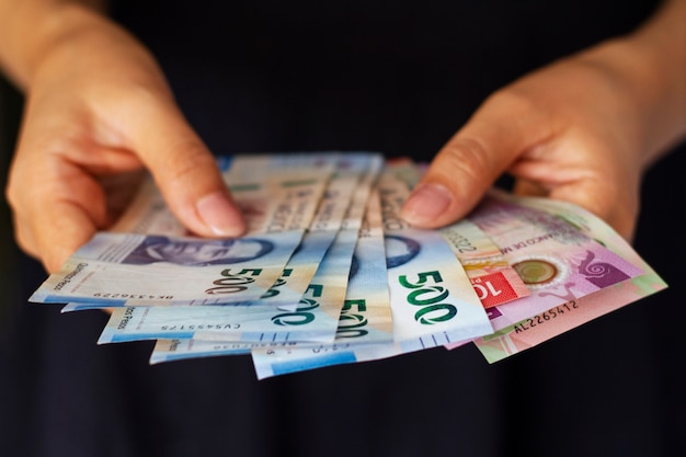 High angle hands holding mexican banknotes