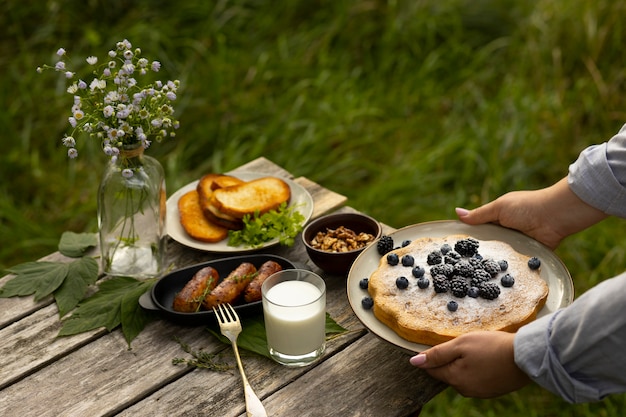 Free Photo high angle hands holding plate with pie