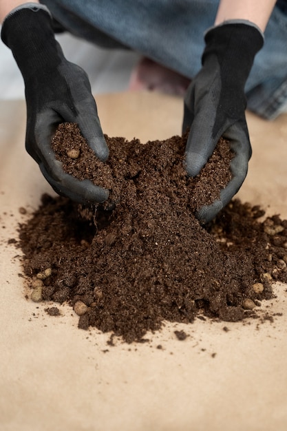 Free photo high angle hands holding potting soil