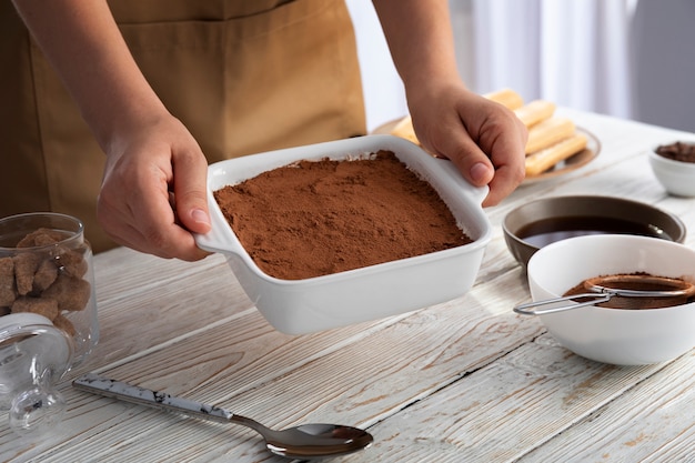 High angle hands holding tiramisu tray