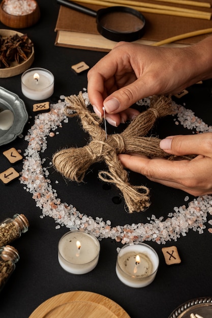 Free photo high angle hands holding  voodoo doll