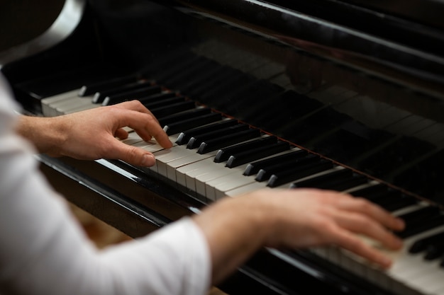 High angle hands playing piano