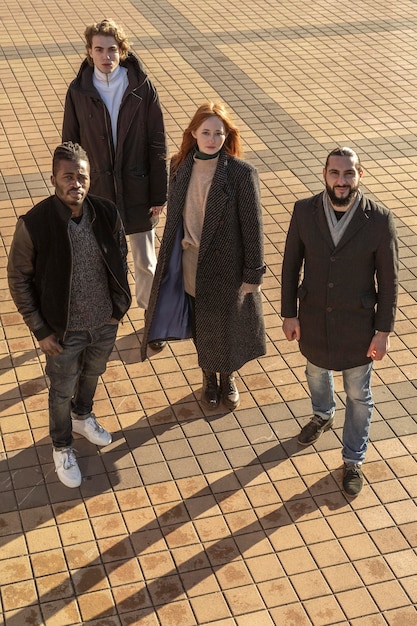 Free photo high angle of handsome men and gorgeous woman outdoors in the sun