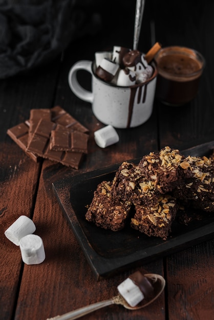 Free photo high angle hot chocolate and brownies with nuts