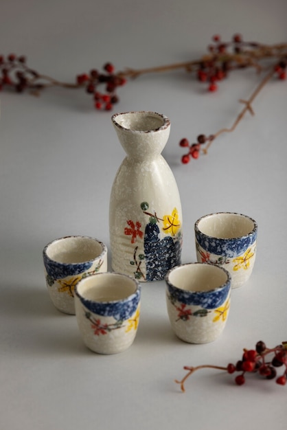 Free photo high angle japanese cups and bottle