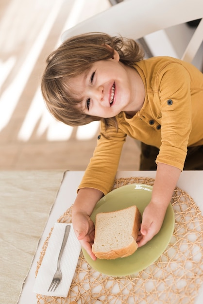 Free Photo high angle kid having breakfast