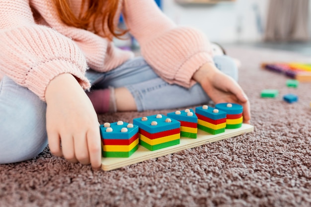 High angle kid holding wooden toy