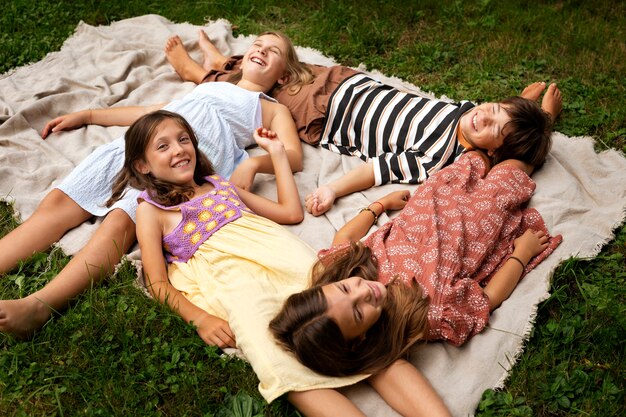 High angle kids laying on blanket