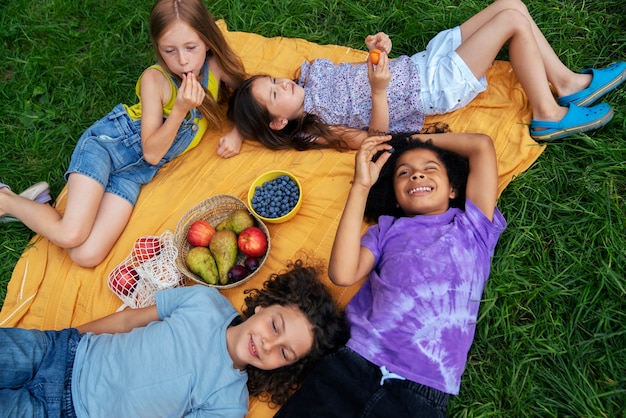 High angle kids laying on cloth