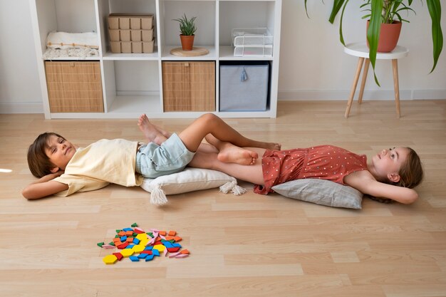 High angle kids laying on floor