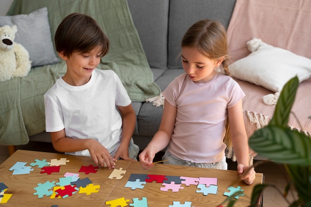 High angle kids making puzzle together