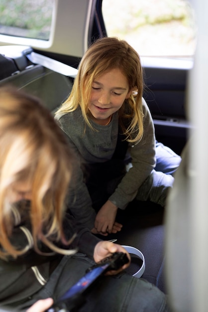 High angle kids playing in the car