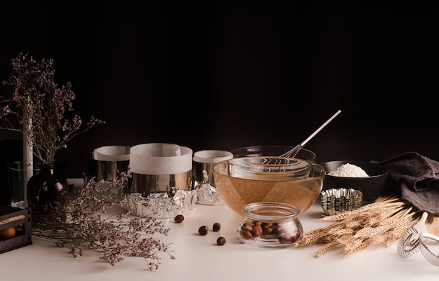 High angle of kitchen pots and bowls with chestnuts and wheat