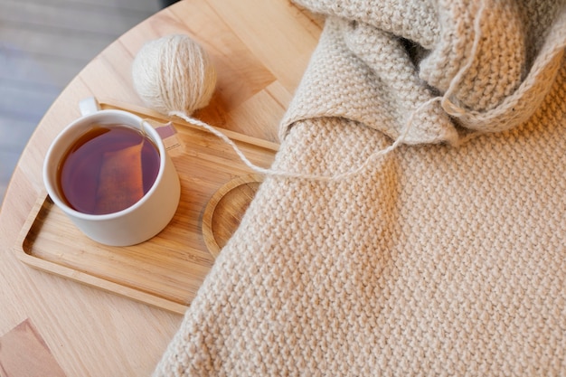 Free photo high angle knitting yarn and tea cup