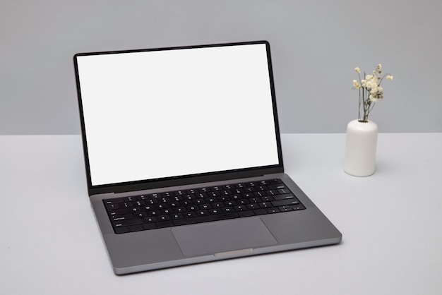 High angle laptop and flowers arrangement