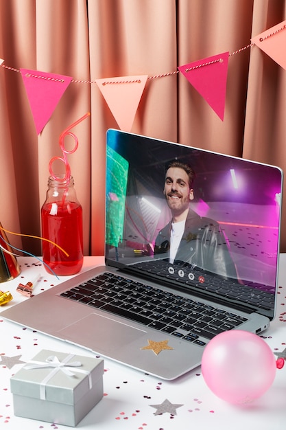 High angle laptop and party decorations arrangement