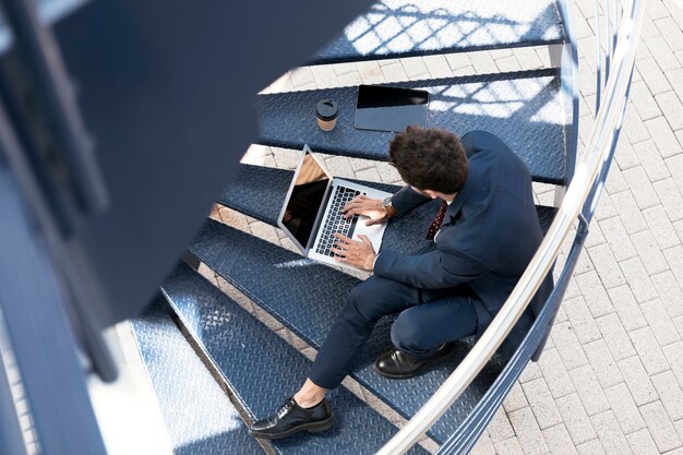 Free Photo high angle lawyer with laptop, tablet and coffee