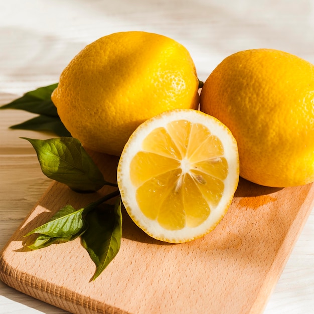 Free photo high angle lemons on wooden board