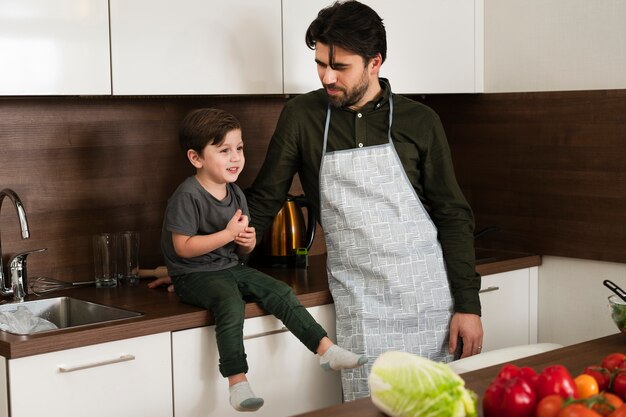 High angle little boy and father in kitchen