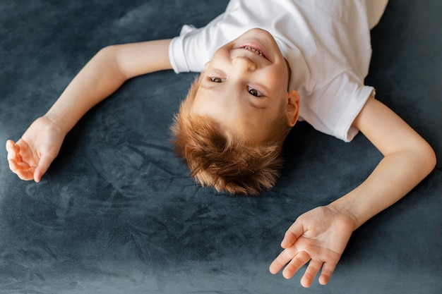 Free photo high angle little boy having fun at home