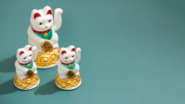 Free photo high angle lucky cats with copy space