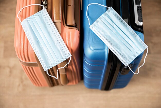 High angle of luggage with medical masks